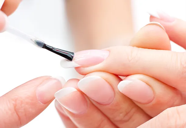 A colour image of beautiful nails being painted - a French manicure by Vicki Hooper Beauty- Grayshott and Headley Down